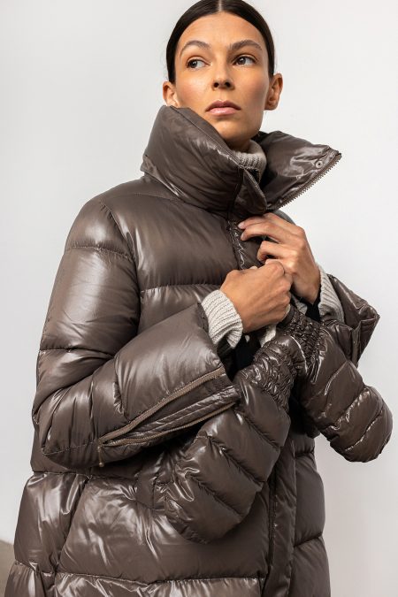 Down jacket in a cool shade of greyish brown with a slight sheen, high collar, convenient pockets and zips on the sleeves. This down jacket expands downwards like the iconic bell bottoms.