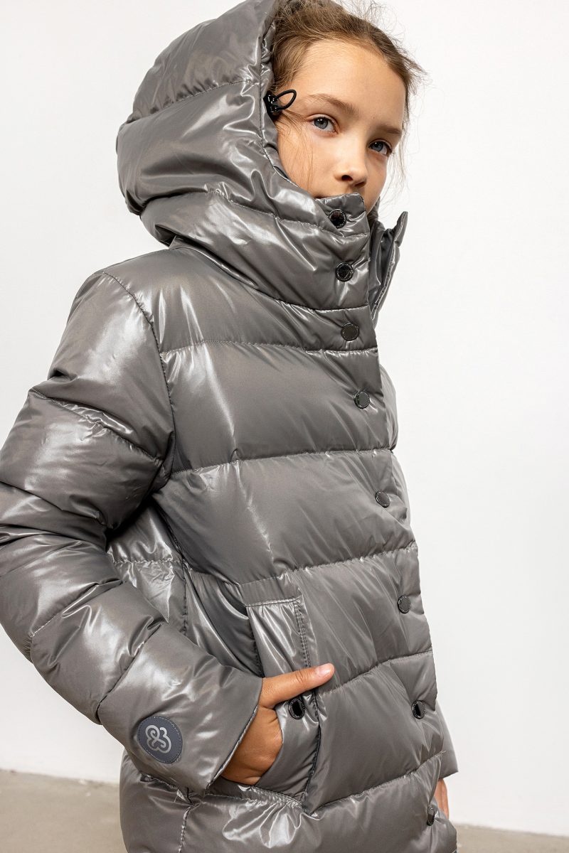 Girl in winter coat in deep grey colour and hood on