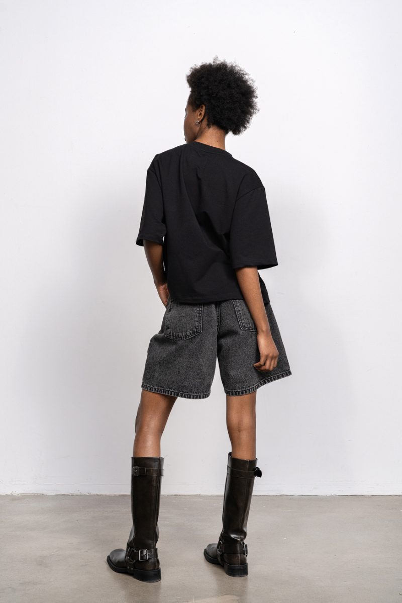 Denim shorts mid-rise with loose leg; front and back pockets, blacked washed denim.