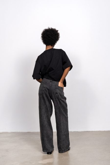 Denim trousers mid-rise with loose leg; front and back pockets, blacked washed denim.