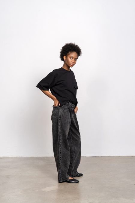 Denim trousers mid-rise with loose leg; front and back pockets, blacked washed denim.