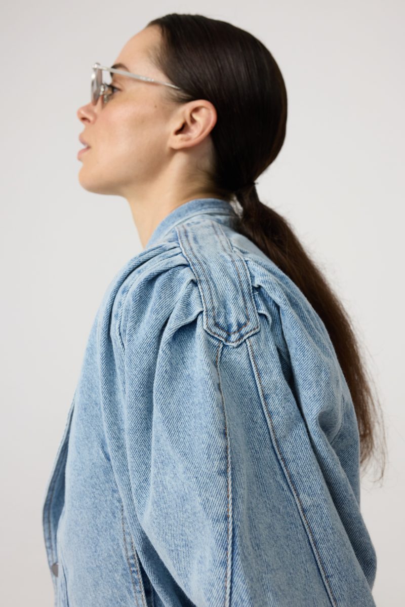 Denim jacket with wide shoulder, soft light denim and buttons on the front.