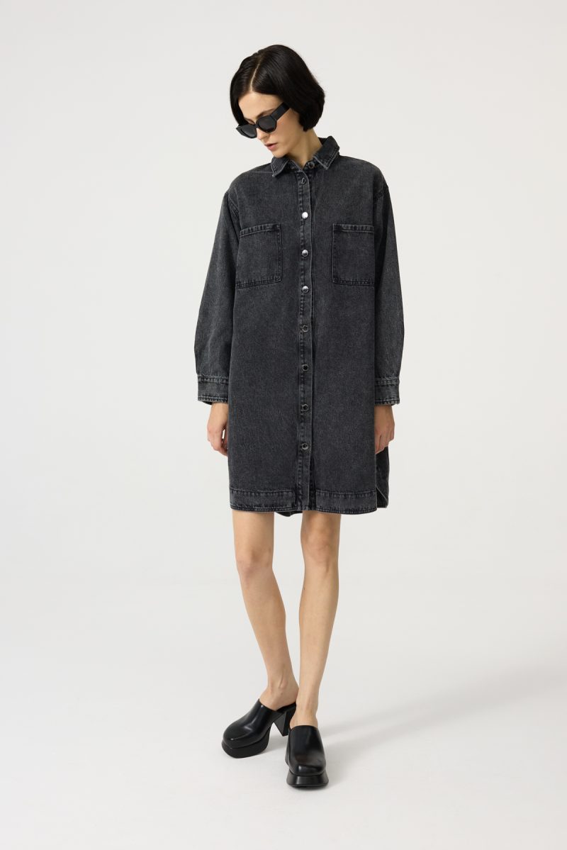 Denim dress with front and side pockets, black-washed denim, straight loose cut. Button fastening.